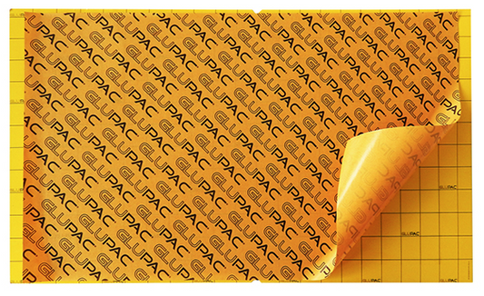 A stack of yellow glueboards with the branding 'PAC' printed on each one.