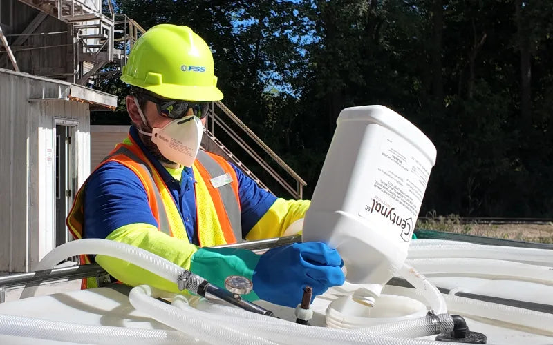 FSS technician adding Centynal EC grain protectant to an application tank at a grain facility