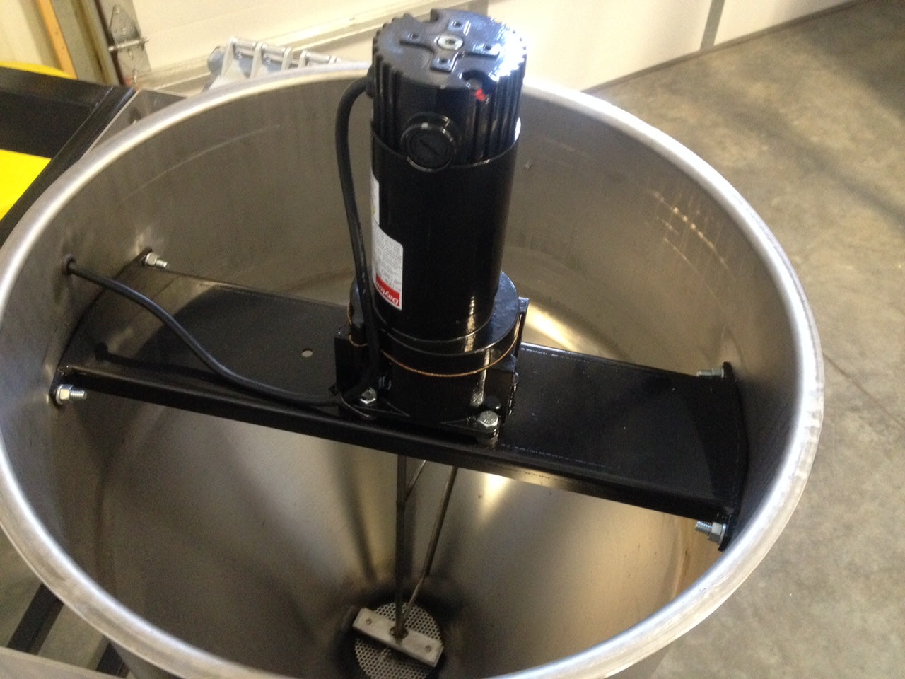 Motor attached to a large metal mixing bowl