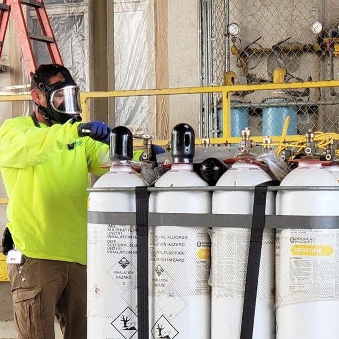 FSS service technicians performing pest-control work inside a commercial milling facility