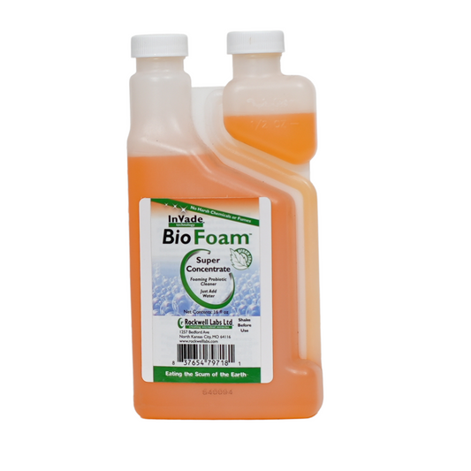 A bottle of InVade BioFoam, an orange-colored cleaning solution in a translucent bottle with a white cap, labeled for use in commercial kitchens.